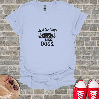 Light blue t-shirt with "What can I say? I LIKE DOGS." text and paw prints.