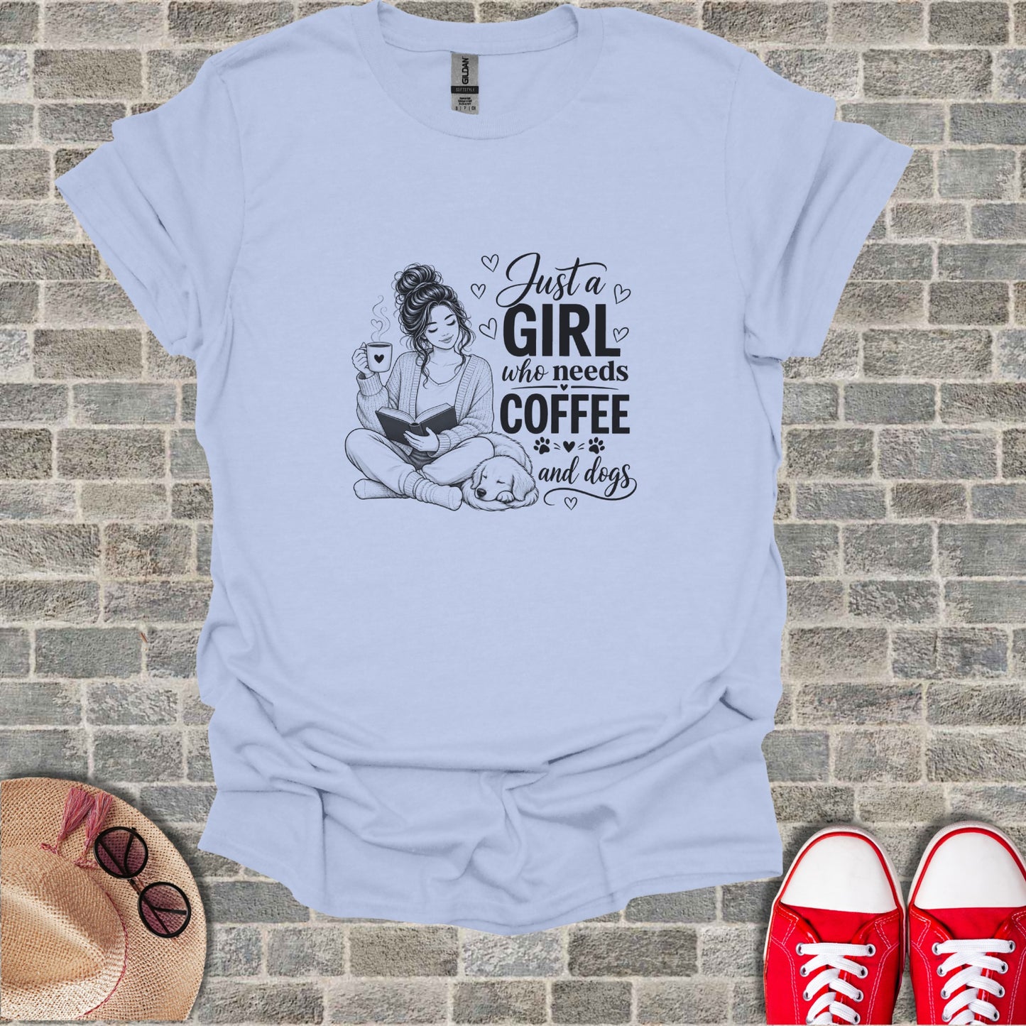Light blue t-shirt with "Just a girl who needs coffee and dogs" text and illustration.