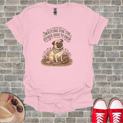 Pink t-shirt with pug graphic and text "Waiting for the other shoe to drop".