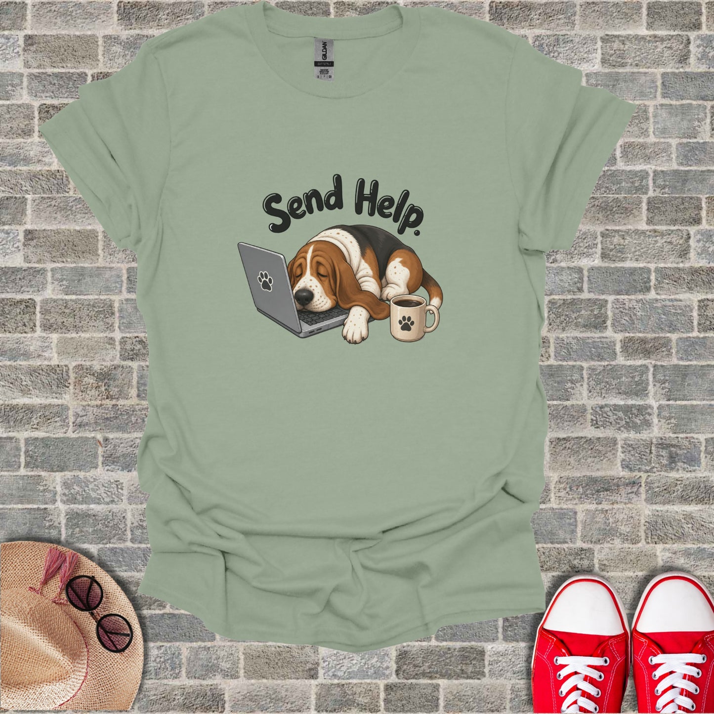 T-shirt graphic of a dog sleeping on a laptop with a coffee cup.