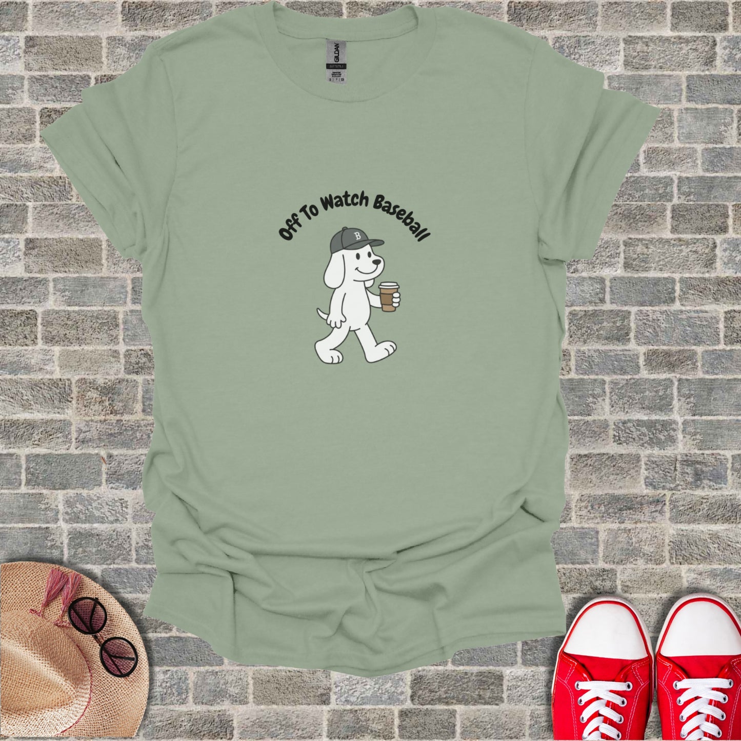 Cartoon dog in a hat holding coffee, text "Off To Watch Baseball".