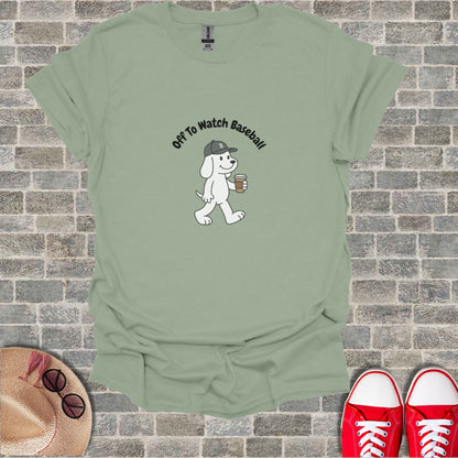 Cartoon dog in a hat holding coffee, text "Off To Watch Baseball".