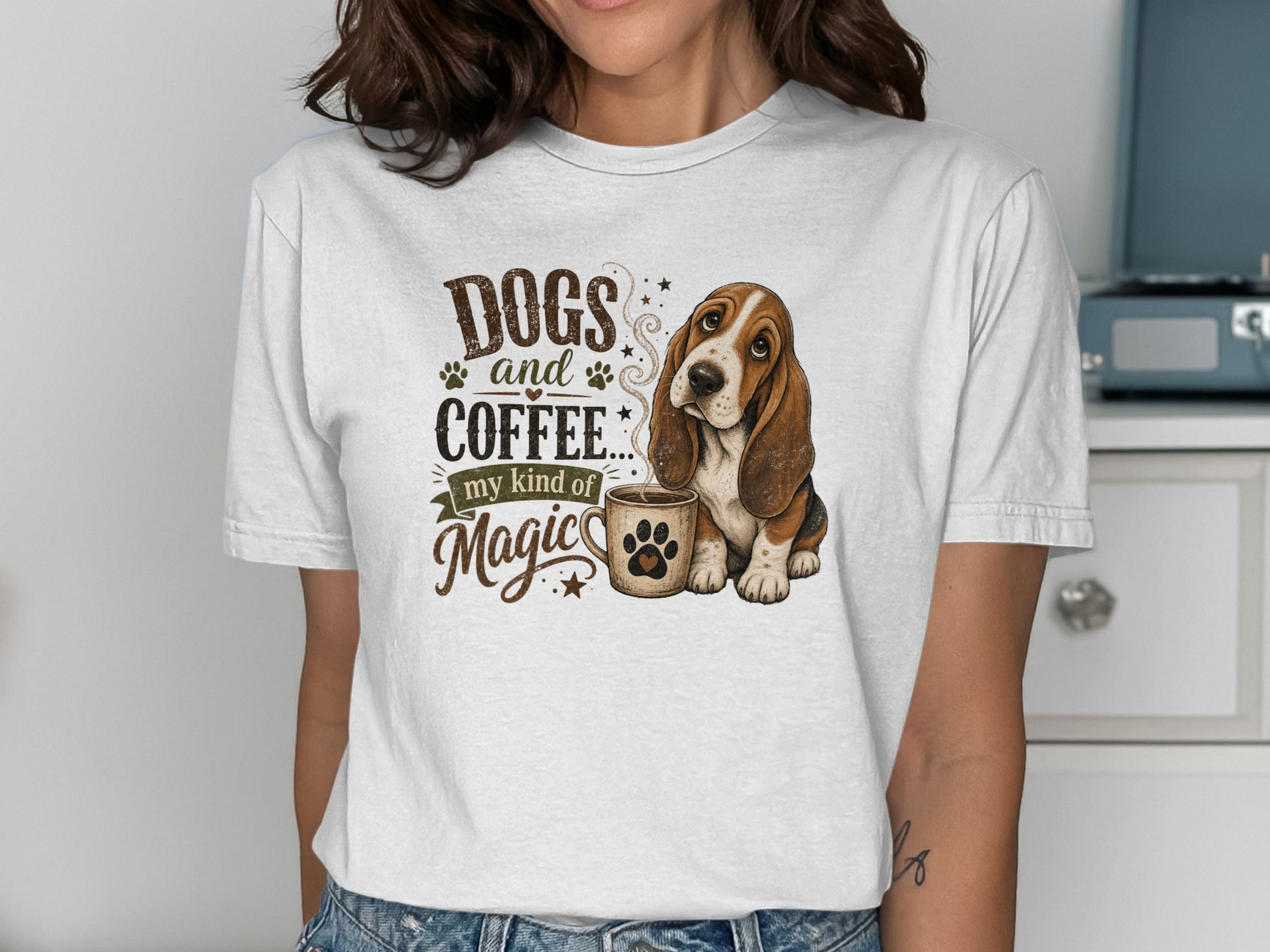 Basset hound with "Dogs and coffee... my kind of magic" text on a white t-shirt.