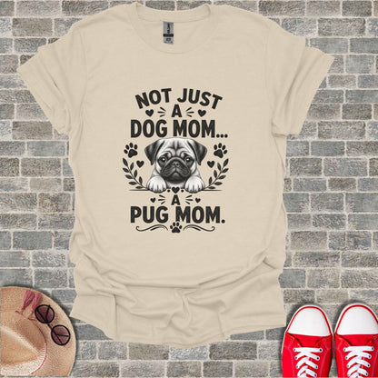 Cream t-shirt with a pug graphic and text "Not just a dog mom... a pug mom."