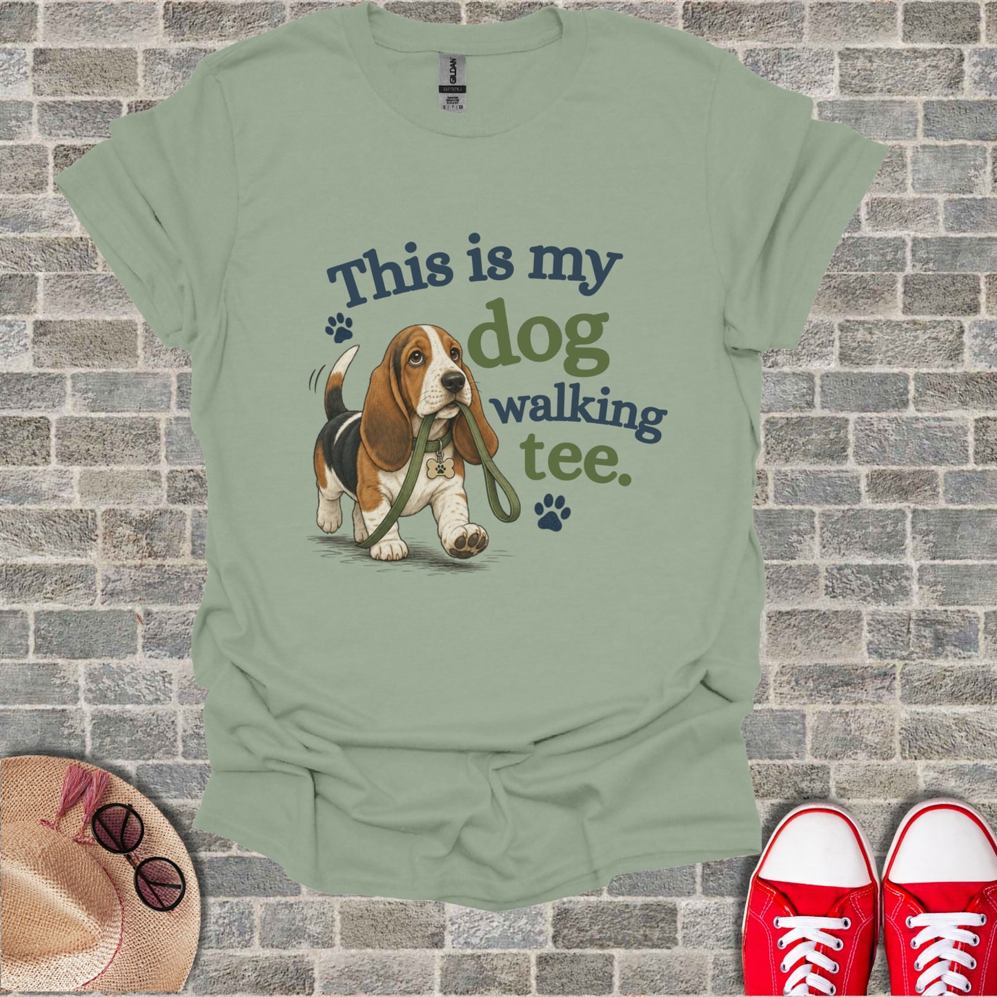 Basset hound wearing a leash with "This is my dog walking tee" text.