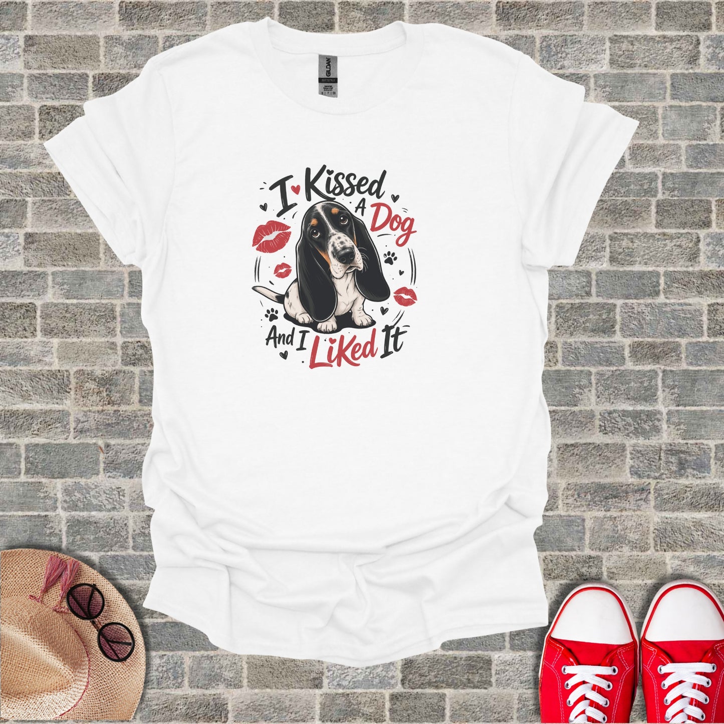 White t-shirt with graphic of a Basset Hound and "I Kissed A Dog And I Liked It" text.