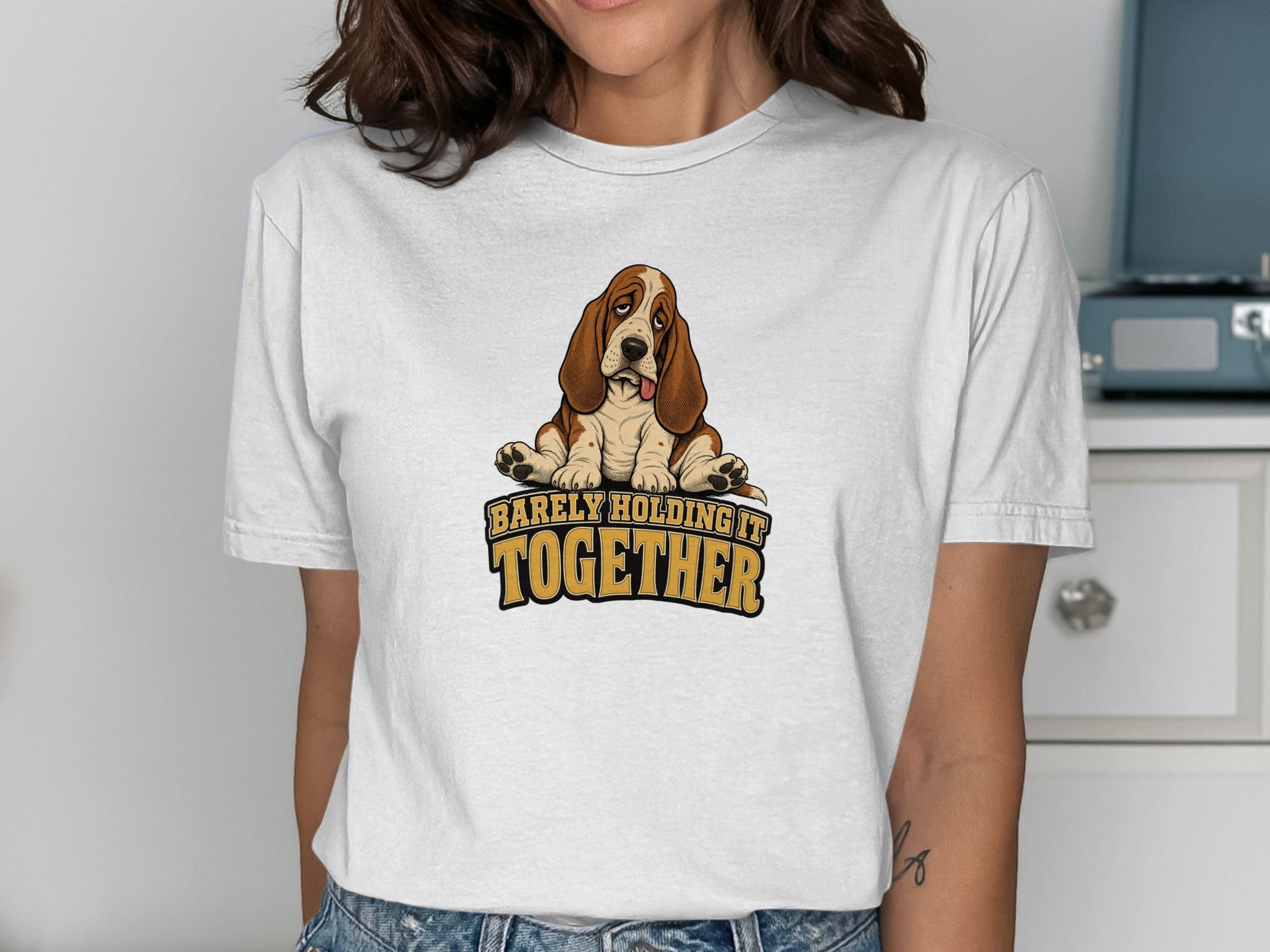 White t-shirt with a Basset Hound graphic and "BARELY HOLDING IT TOGETHER" text.