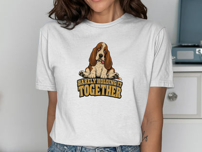 White t-shirt with a Basset Hound graphic and "BARELY HOLDING IT TOGETHER" text.