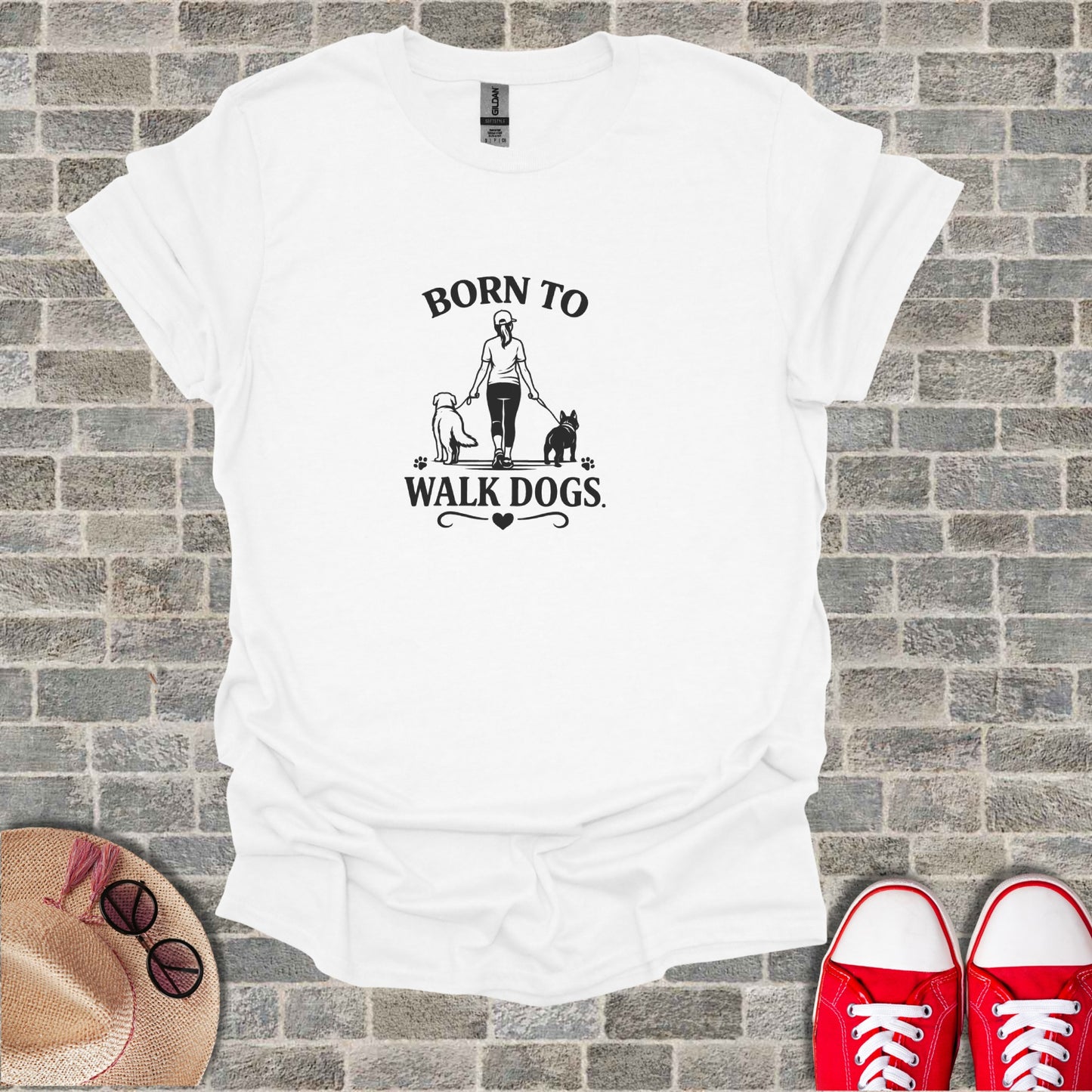 White t-shirt with "Born to Walk Dogs" graphic featuring a person and two dogs.
