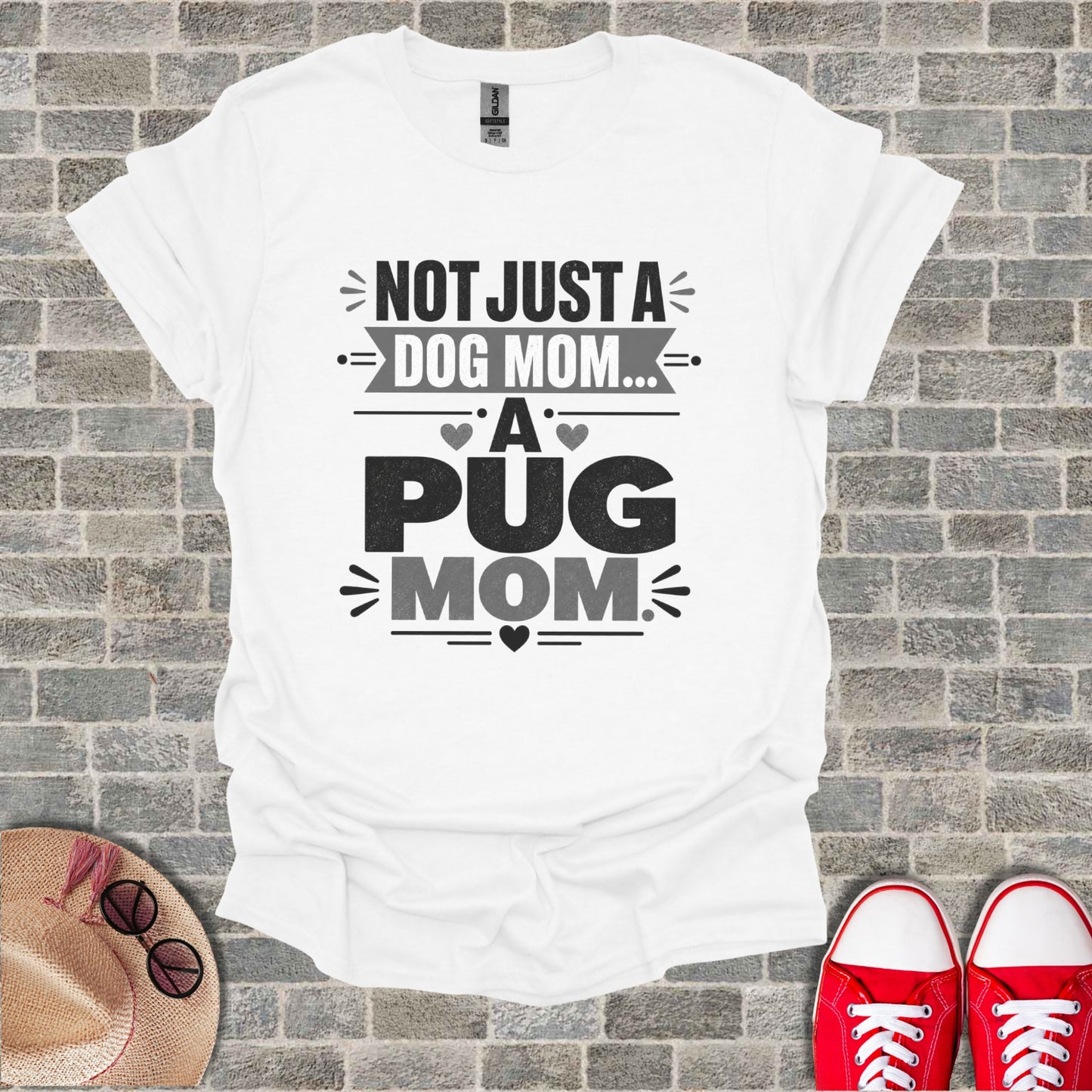 White t-shirt with "Not Just A Dog Mom... A Pug Mom" text and graphic design.
