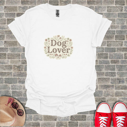 White t-shirt with "Dog Lover" text surrounded by flowers and mushrooms.