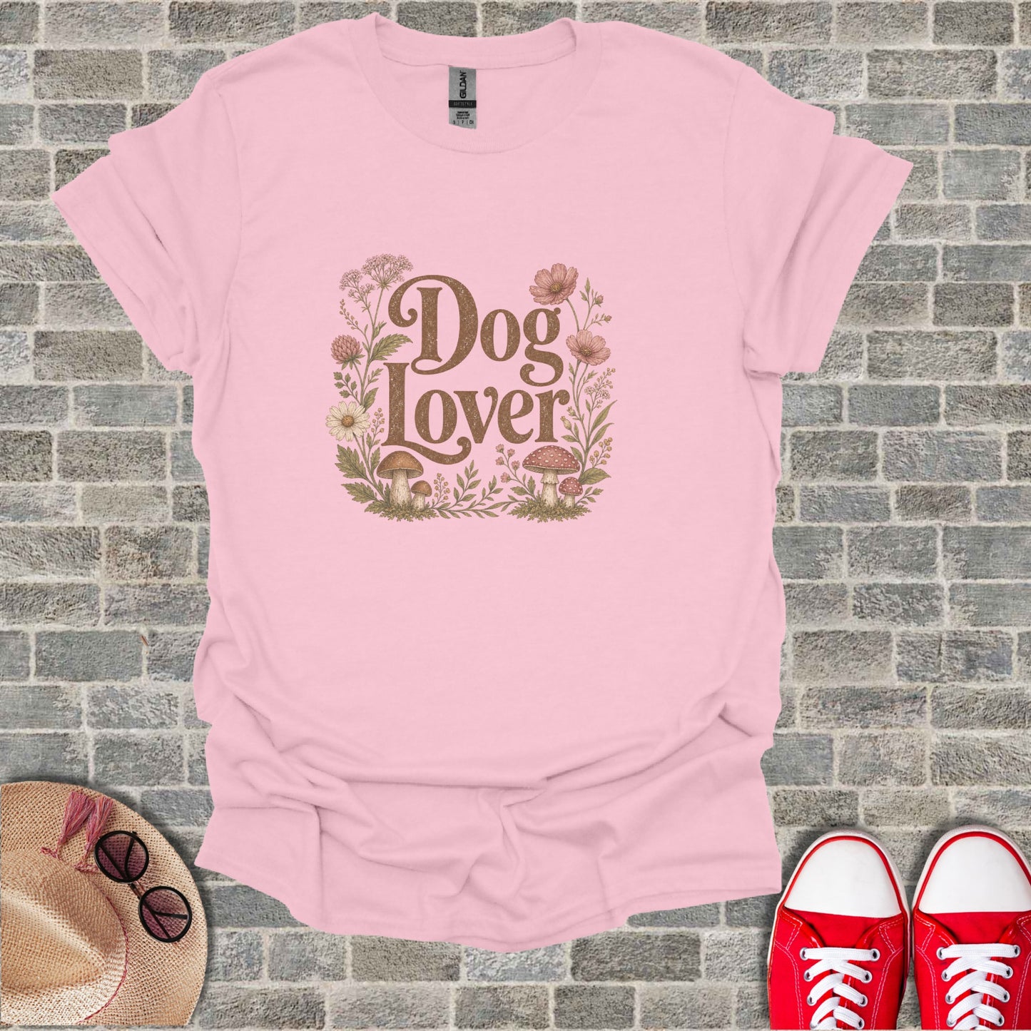 Pink t-shirt with "Dog Lover" text surrounded by flowers and mushrooms.
