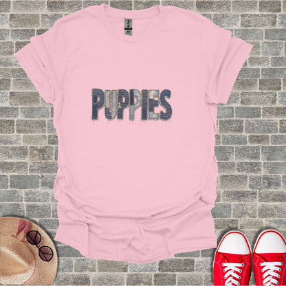 Pink t-shirt with "PUPPIES" in distressed denim font.