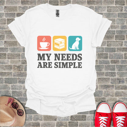 White t-shirt with icons for coffee, books, dog, and text "My Needs Are Simple."