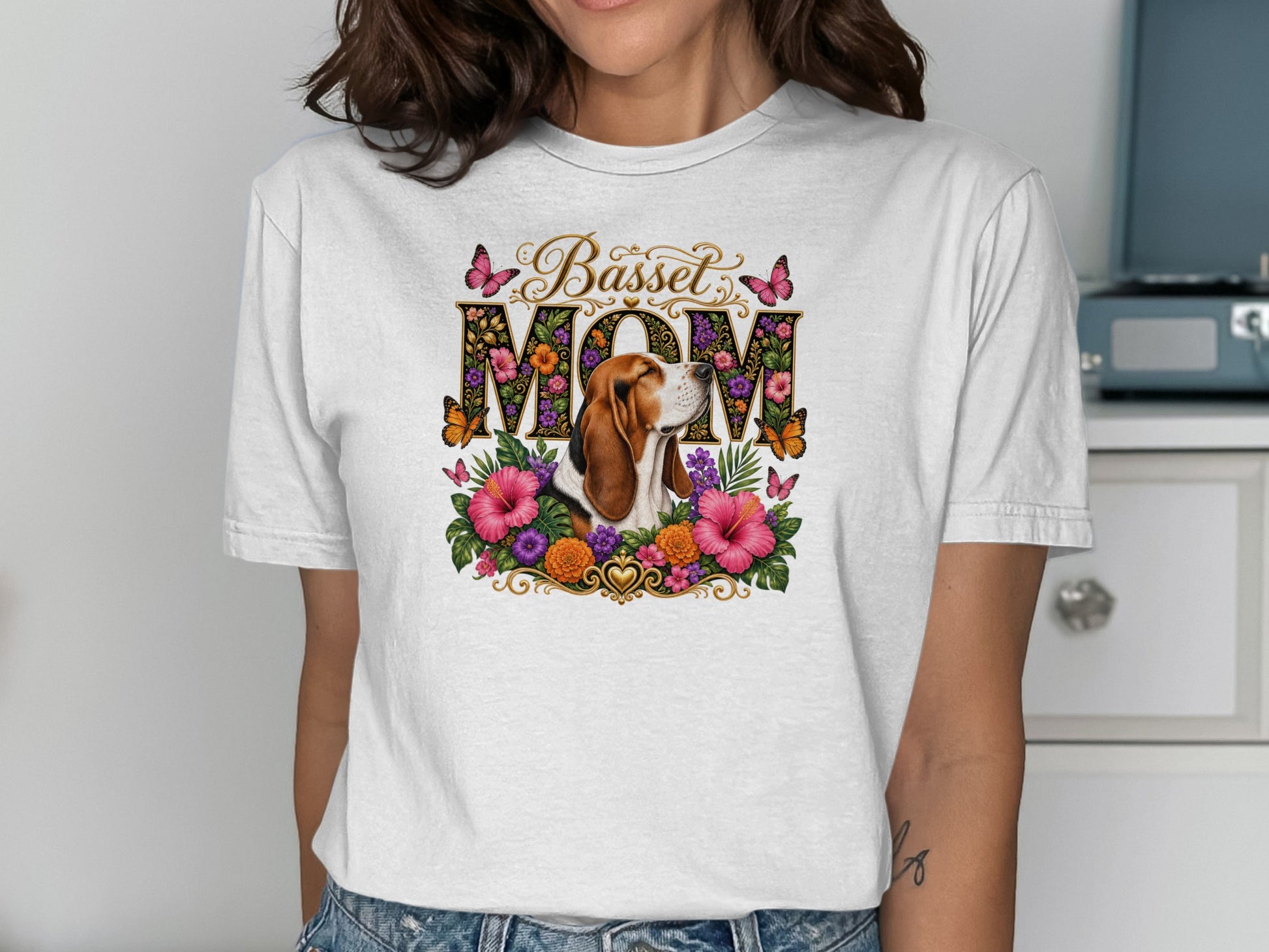 Basset Hound Mom graphic with floral accents and butterflies on white t-shirt.