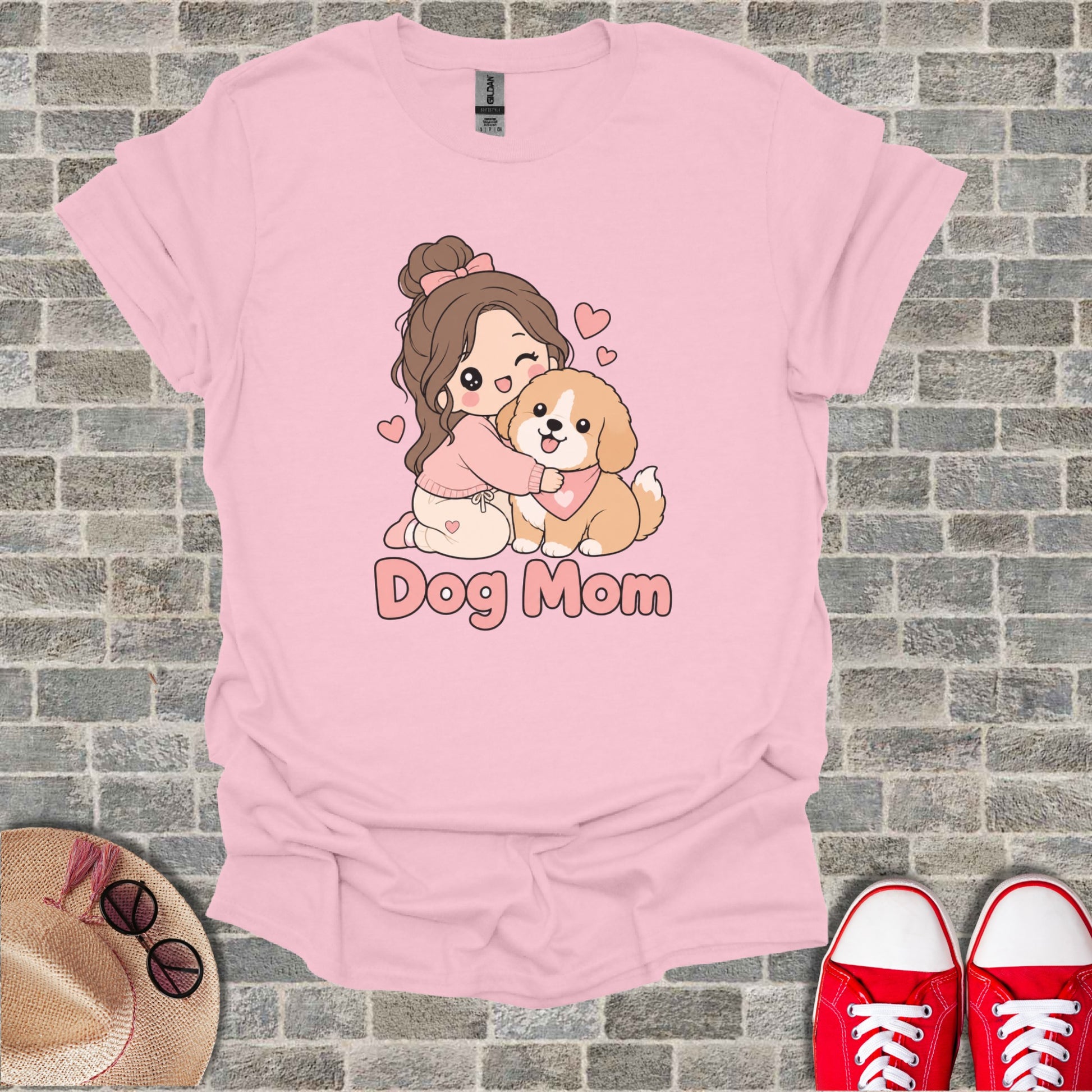 Pink t-shirt with cartoon girl hugging a dog, text Dog Mom.