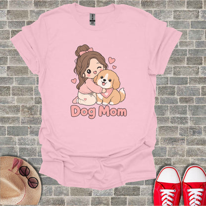 Pink t-shirt with cartoon girl hugging a dog, text Dog Mom.