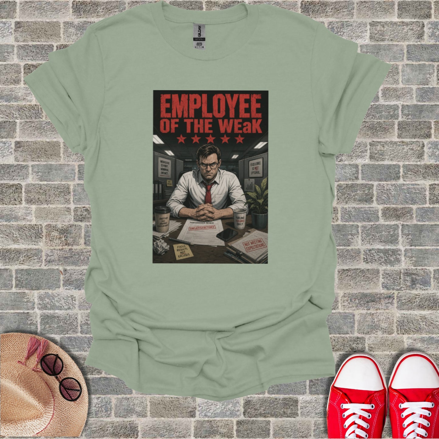 T-shirt with "Employee of the Weak" text and humorous office imagery.