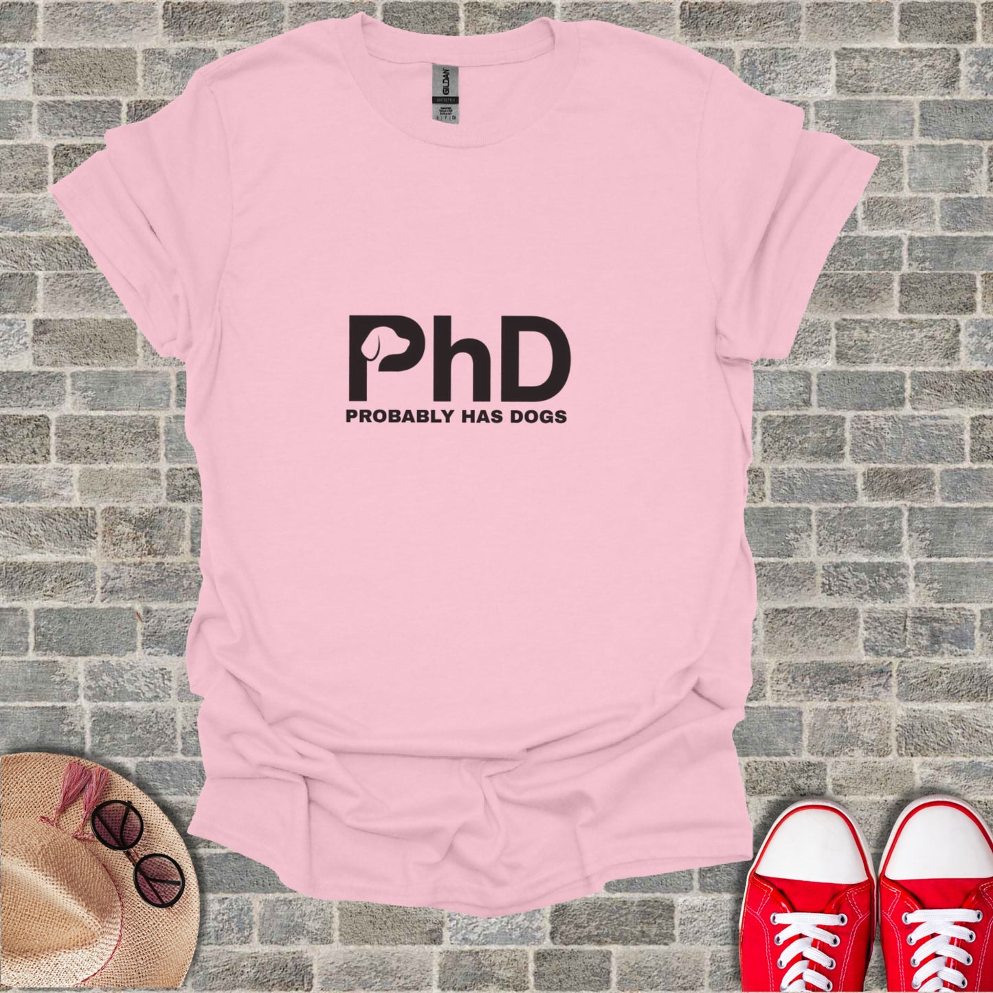 Pink t-shirt with "PhD PROBABLY HAS DOGS" text.