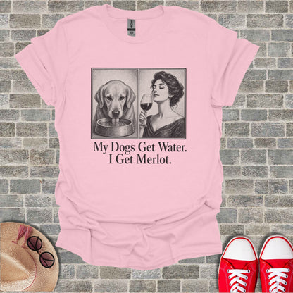 Pink t-shirt with sketch of dog drinking water and woman with wine, text "My Dogs Get Water. I Get Merlot."