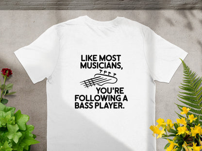 White t-shirt with black text and bass guitar graphic: "Like most musicians, you're following a bass player."