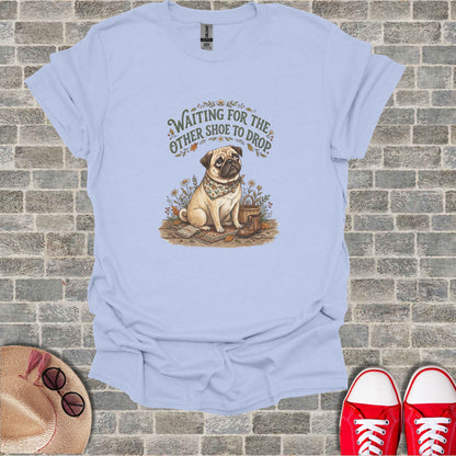 T-shirt graphic featuring a dog wearing a bandana next to scattered boots and flowers.