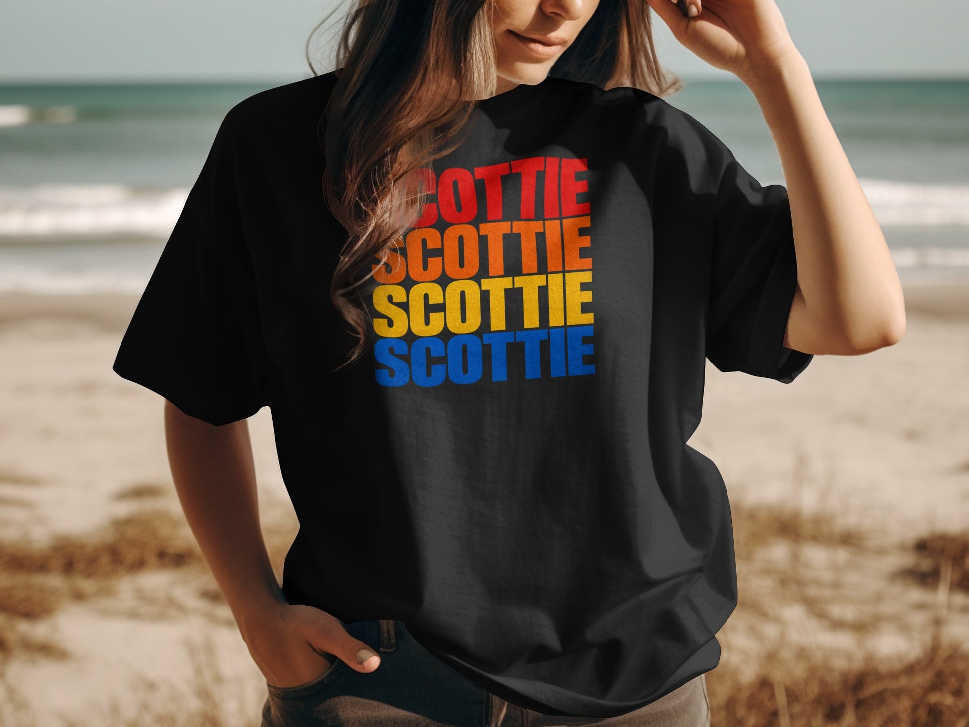 Black t-shirt with stacked "SCOTTIE" text in orange, red, yellow, and blue.