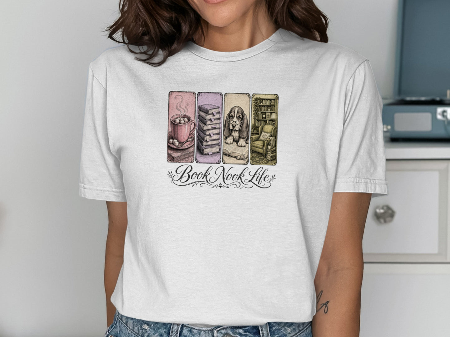 T-shirt with "Book Nook Life" featuring stacked books, dog in armchair, and coffee.