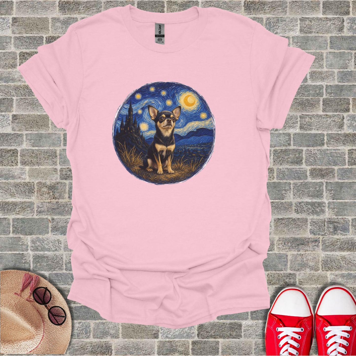 Chihuahua against a starry night sky, on a pink t-shirt.