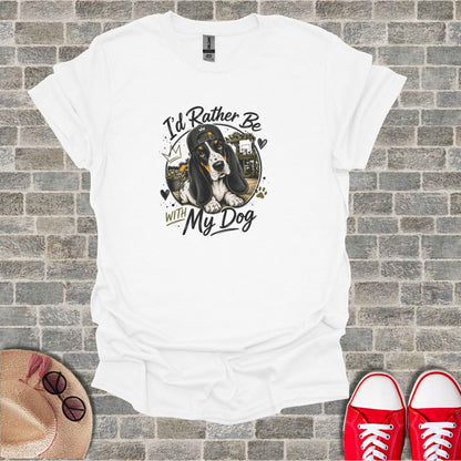 White t-shirt with graphic of a basset hound wearing a baseball cap and text "I'd Rather Be With My Dog".