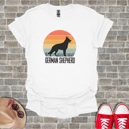 White t-shirt with a German Shepherd silhouette and sunset graphic.