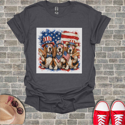 Three dogs wearing hats and bandanas hold hot dogs with an American flag background.