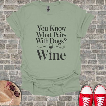 Light green t-shirt with black text: "You Know What Pairs With Dogs? Wine".