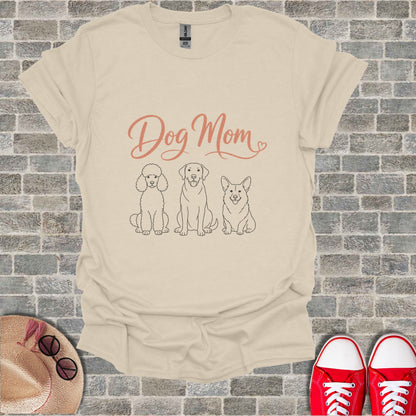 Cream t-shirt with "Dog Mom" text and poodle, lab, and corgi illustrations.